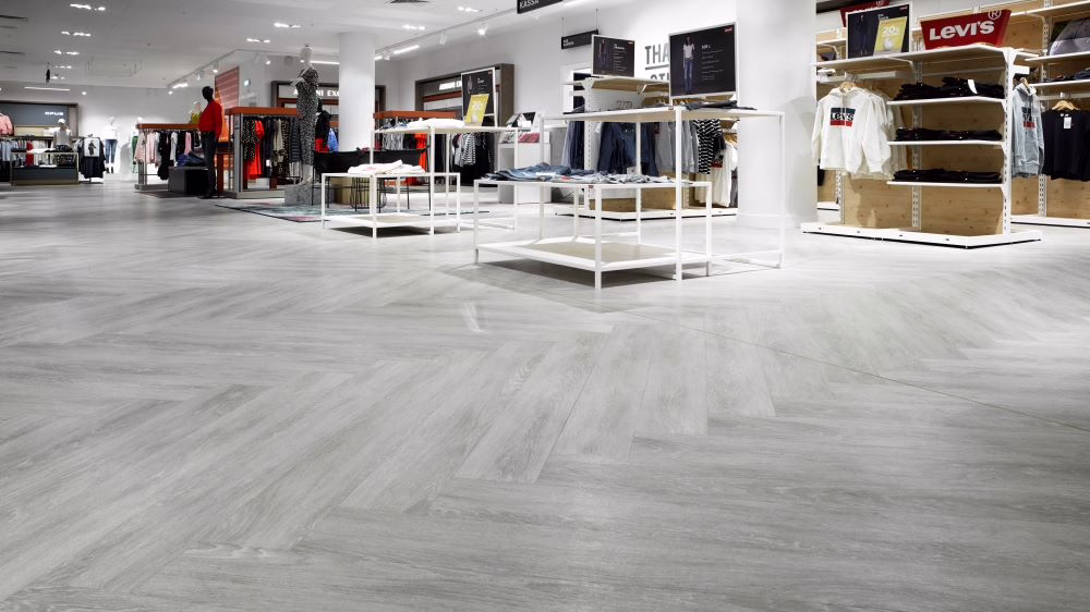 The sales area of a clothes shop with herringbone tiles