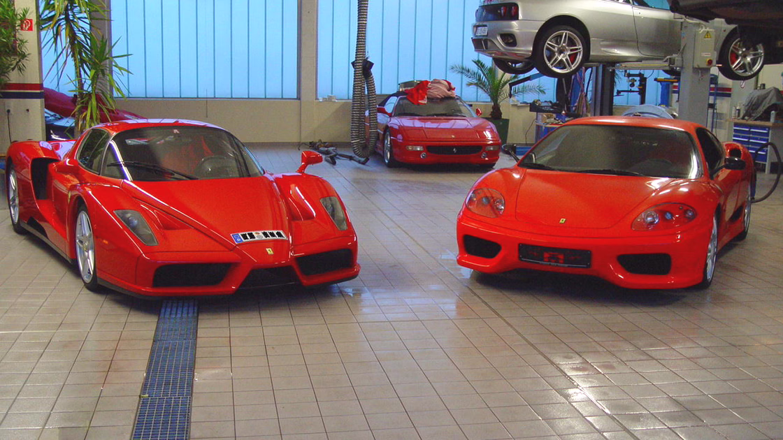 Two Ferraris stand on the newly laid tiled floor